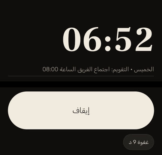 شاشة من التطبيق ببيانات توضيحية: المنبه يرن في الساعة 06:52، وتحت الساعة «الخميس • التقويم: اجتماع الفريق الساعة 08:00»، وفي الأسفل زرا «إيقاف» و«غفوة 9 د».